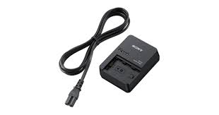 Black compact battery charger with an attached power cord, shown from a top‑side angle